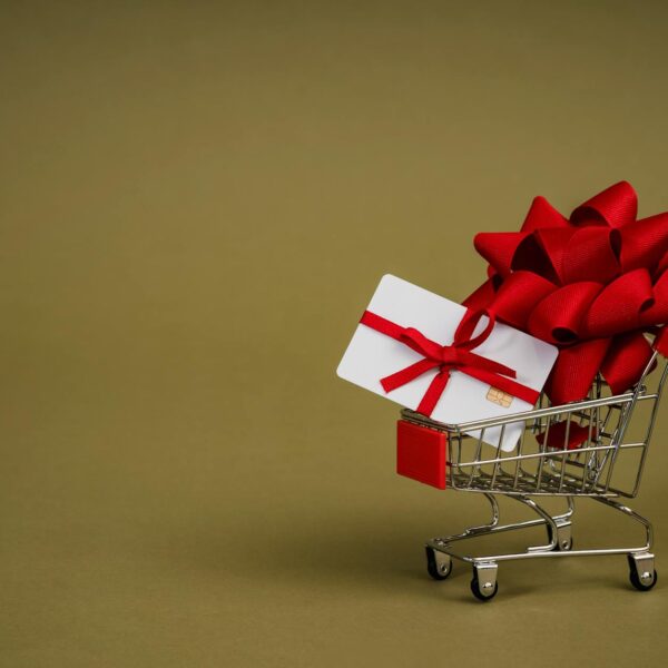 A Mini Shopping Cart with a Bank Card Wrapped in a Red Ribbon